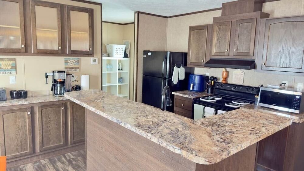 Fully-equipped kitchen with granite counters and stainless steel appliances