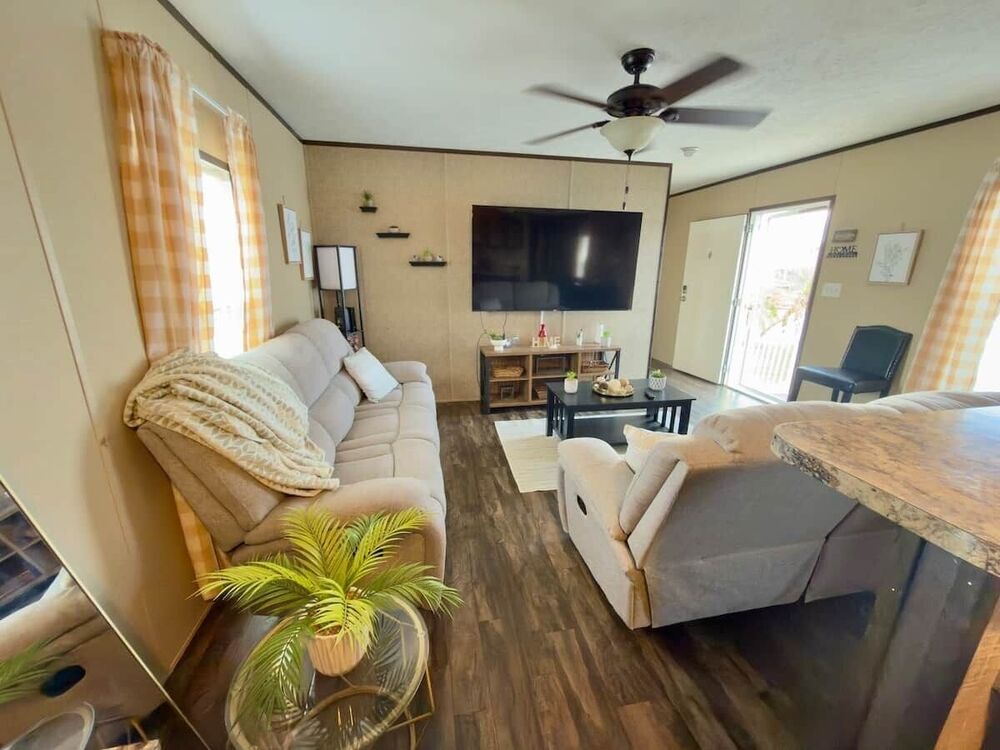 Bright living room with sofa and smart TV at Winter Haven Comfort Retreat in Winter Haven, FL