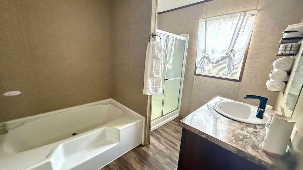 Master bathroom with soaking tub, glass shower and vanity