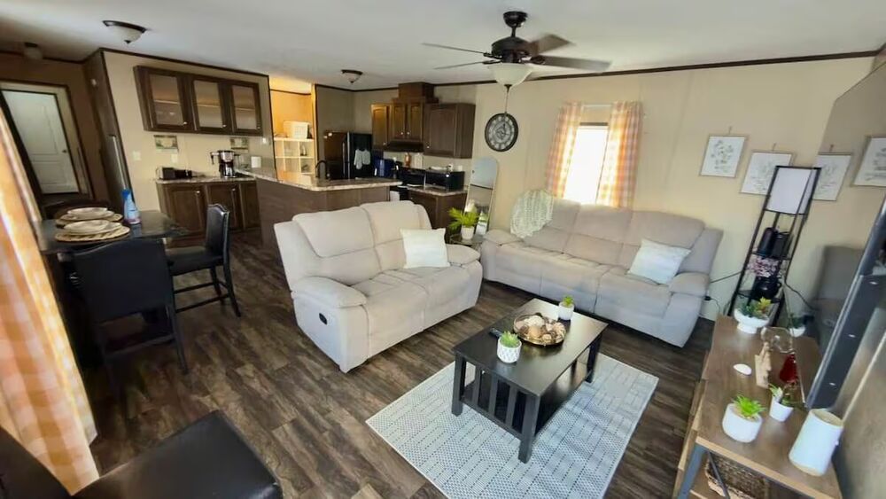 Open-concept living and dining area with wood-look flooring